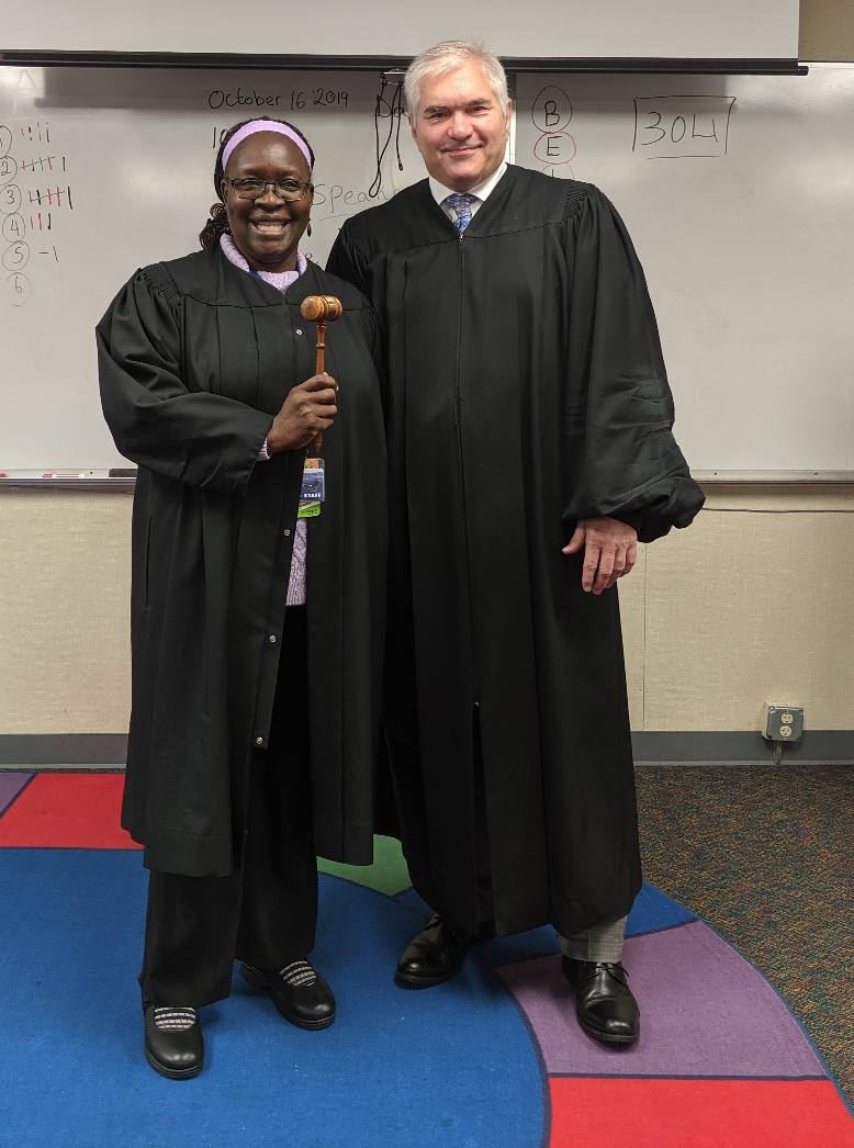 Dave Larson in a classroom, in both teacher and judge attire