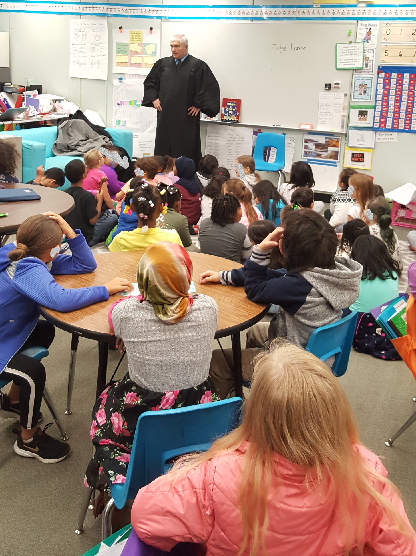 Judge Dave Larson in robes speaking to elementary school students